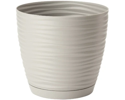 Szara doniczka Sahara Round z rośliną doniczkową na betonowym blacie w industrialnym lofcie