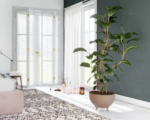 Nowoczesna doniczka Satina na nóżkach stojąca na jasnej podłodze w salonie w stylu loftowym.